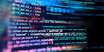 Image of a computer screen with tech code running across it.